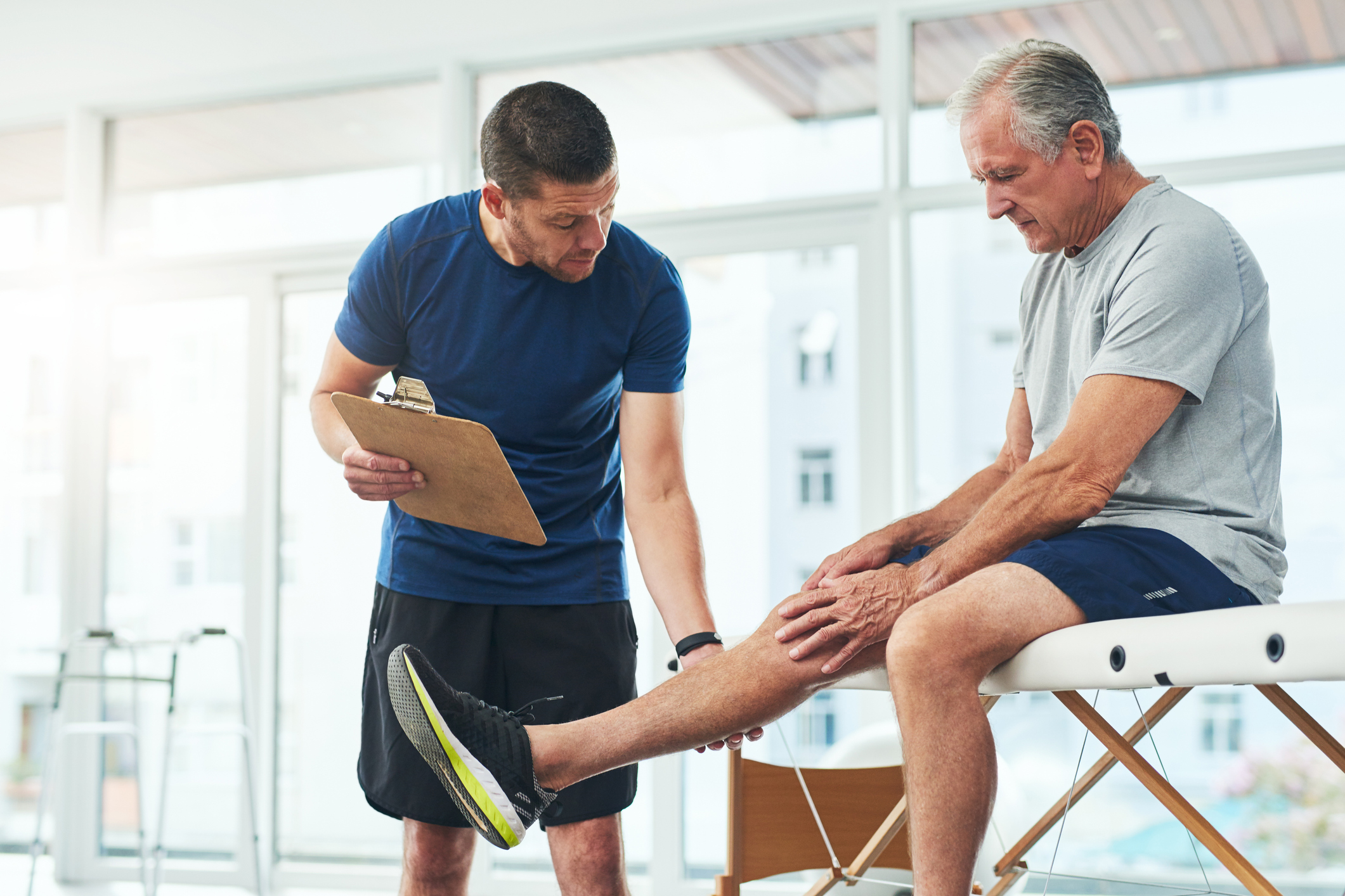 Cropped shot of a handsome young male physiotherapist doing a consultation and assessment with a senior patient